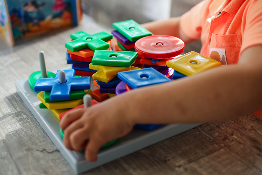 Een peuter aan het leren met speelgoed van Kinderopvang huizen